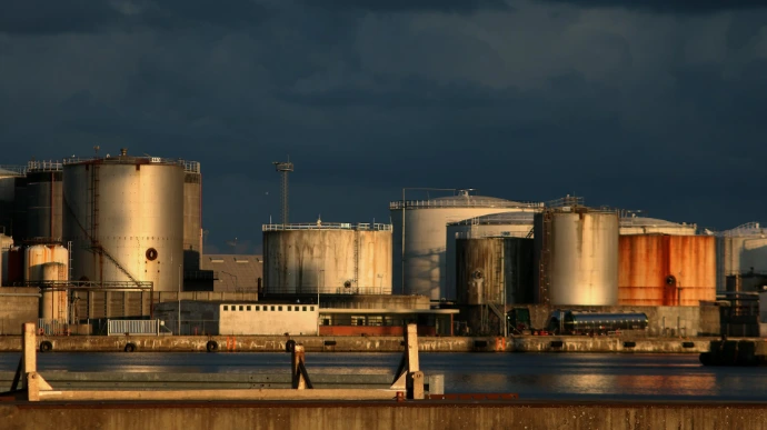 a large industrial area with a body of water in front of it